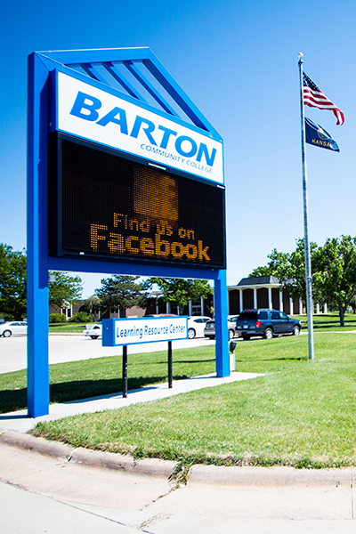 Barton welcome sign with flag