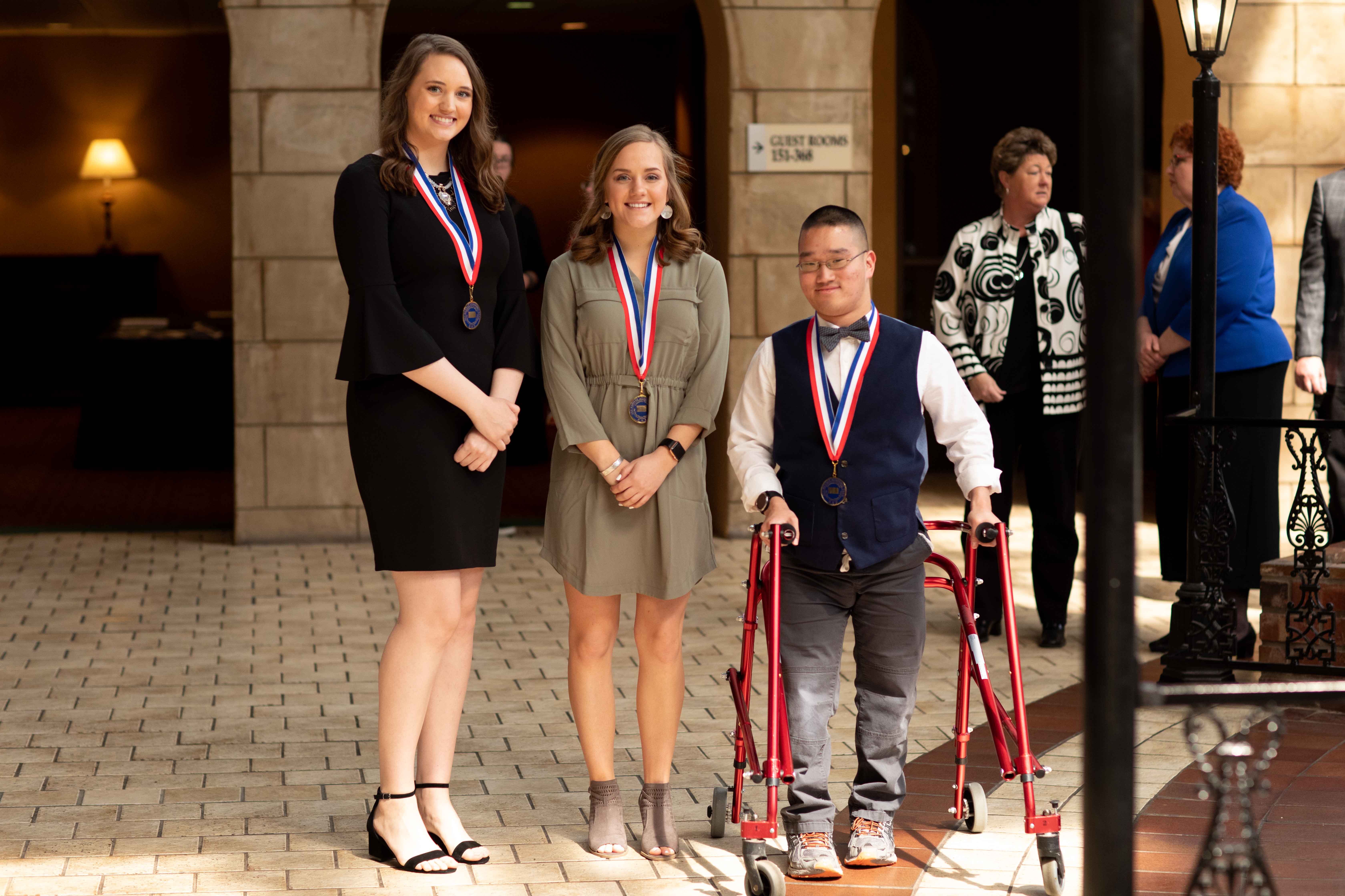 Phi Theta Kappa All-Kansas Academic Team members (from left) Joanna Lockwood and Dawn Ledeboer from the Barton County campus and Samuel Martin from the Fort Riley campus pose for a photo after the PTK awards banquet at the Topeka Ramada Inn Convention Center on Thursday. Not shown is Priscilla Zertuche of the Fort Riley Campus. PTK All-Kansas Academic Team honorees earned medals and certificates to commemorate their achievement.