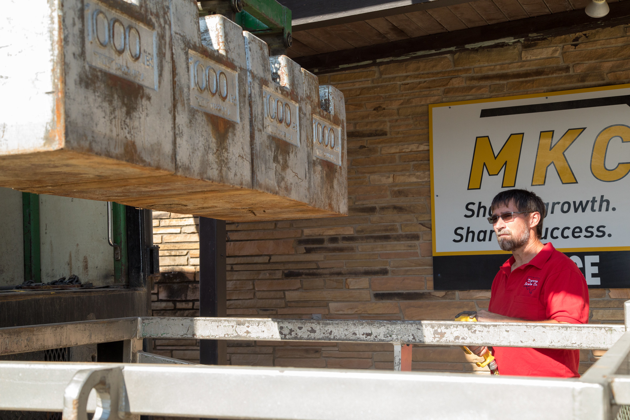 Scale Technician for Travis Scale Co. Kevin Wilson loads 4,000 pounds into a cart to certify a scale in Buhler, Kan.