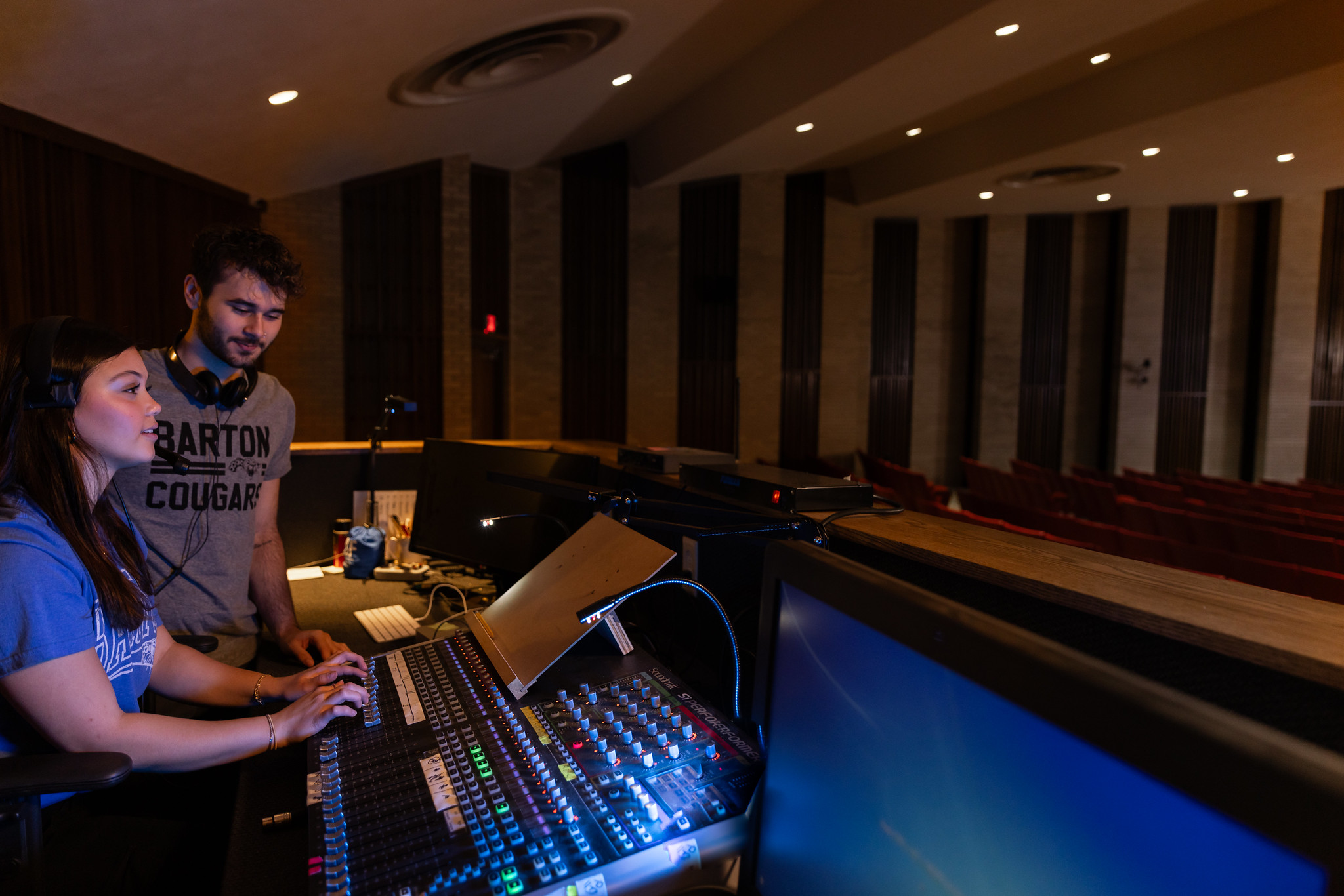 two people working a sound mixer board