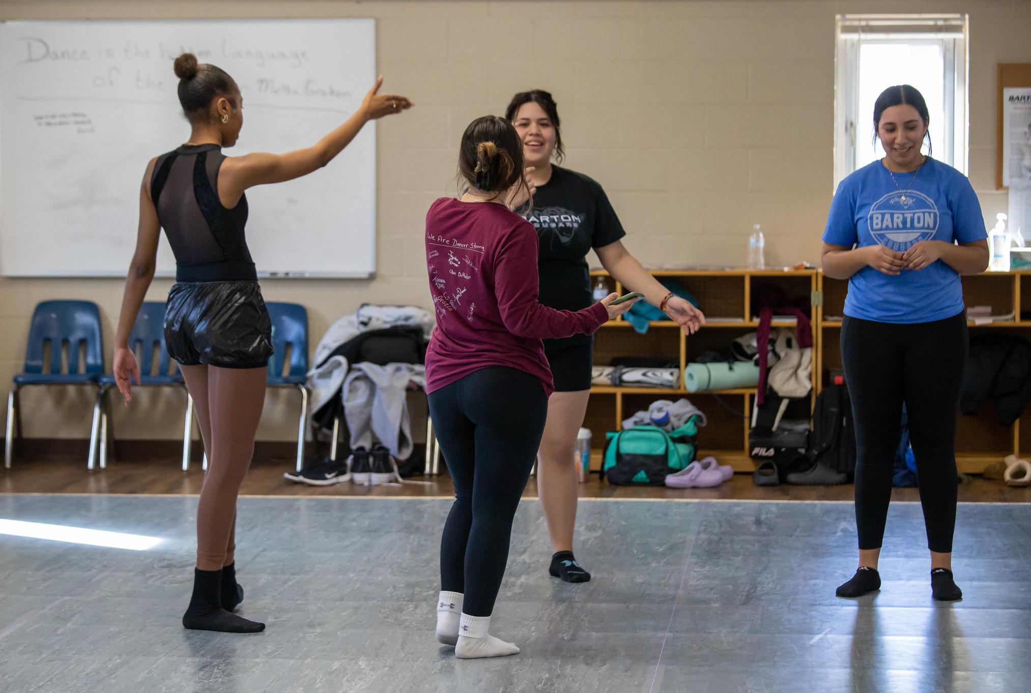 dancers talking to each other in a dance studio