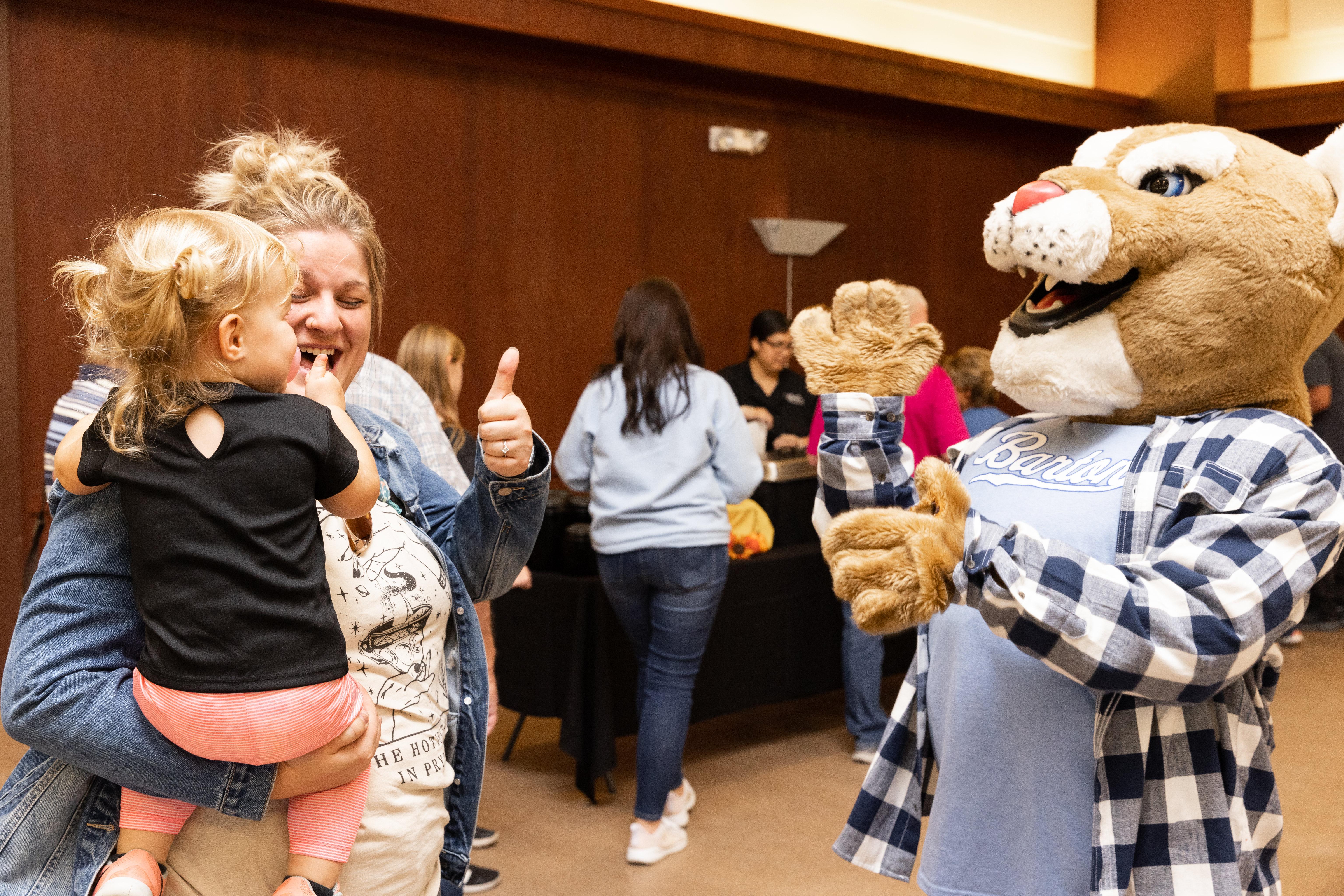 Bart the Cougar interacts with guests of all ages at last year's Chamber of Commerce After Hours hosted by Barton Community College.