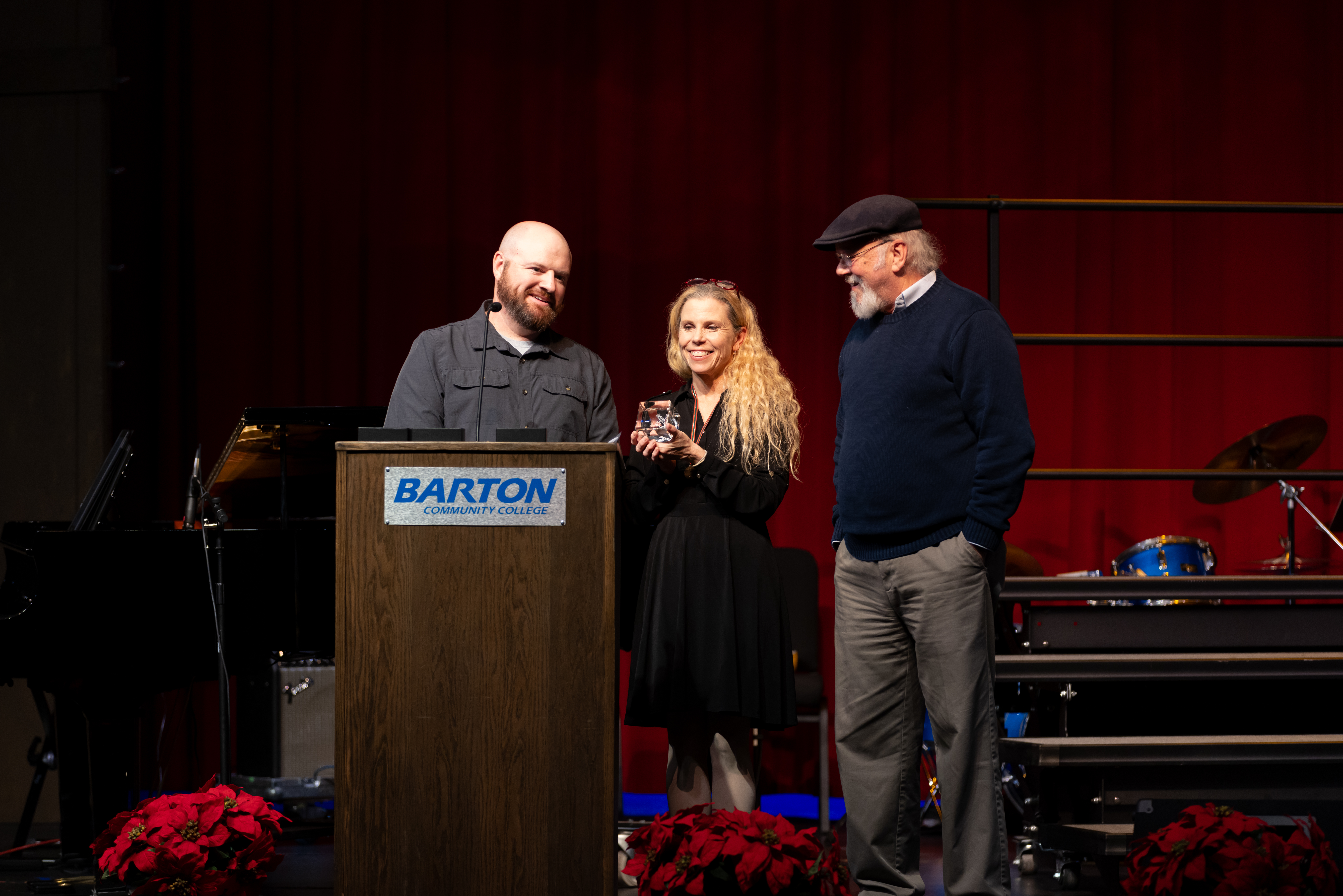 Instructor of Art Mark Freeman (left) accepts the Hall of Fame award from Bielek (middle) and former Director of the Shafer Gallery David Barnes (right)in memory of Steve Dudek. Former Instructor of Art, Dudek fostered creativity in the visual arts for more than 40 years.