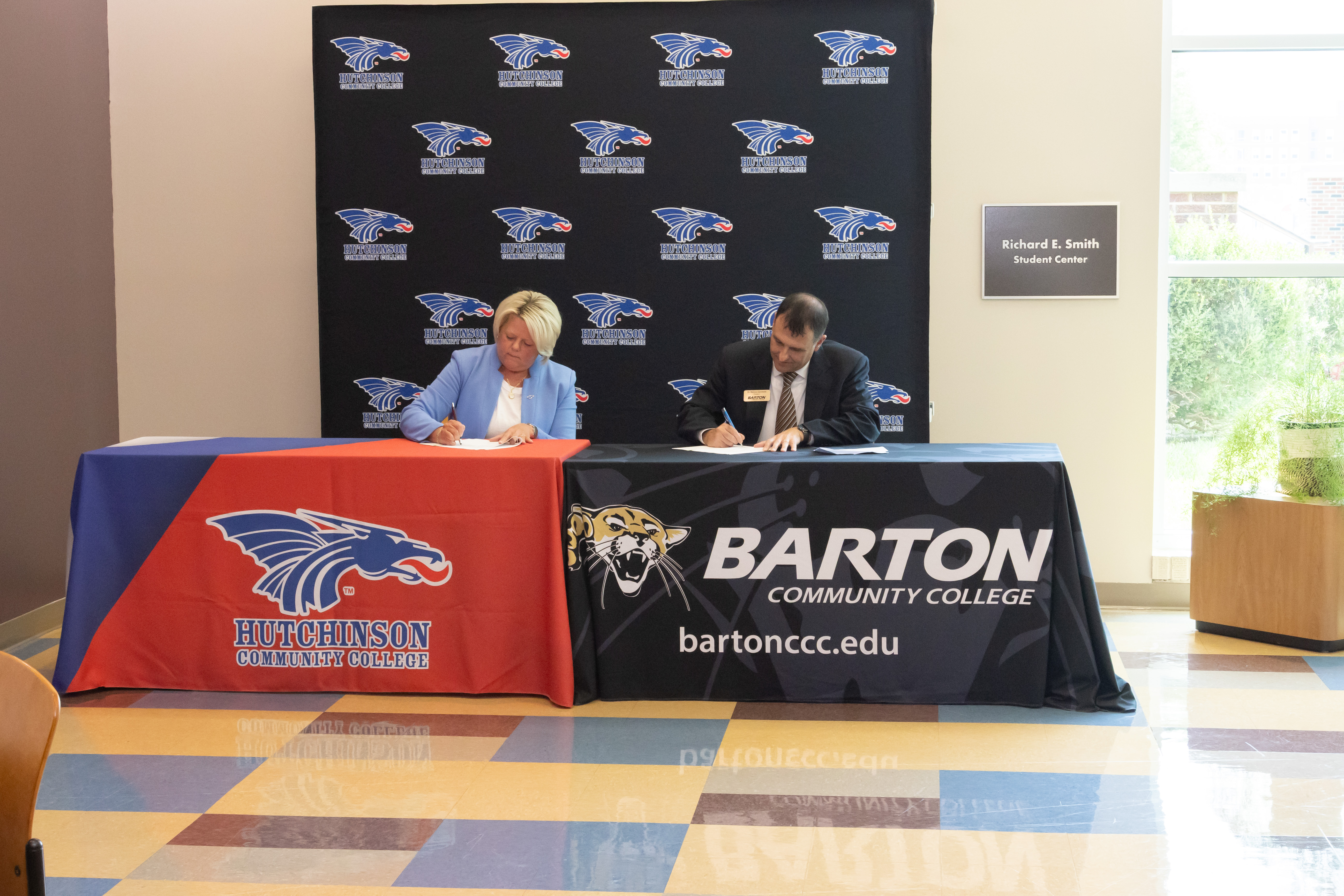 Hutchinson Community College President Dr. Tricia Paramore (left) and Barton Community College President Dr. Marcus Garstecki (right) sign a Memorandum of Understanding to create a new partnership expanding access to respiratory care education in central Kansas.