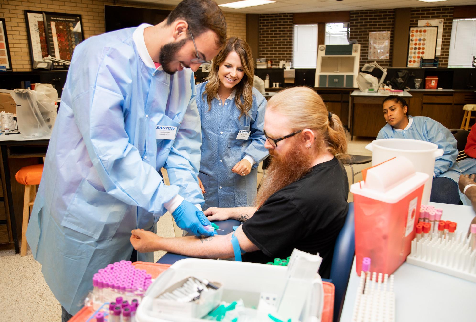 students drawing each others blood