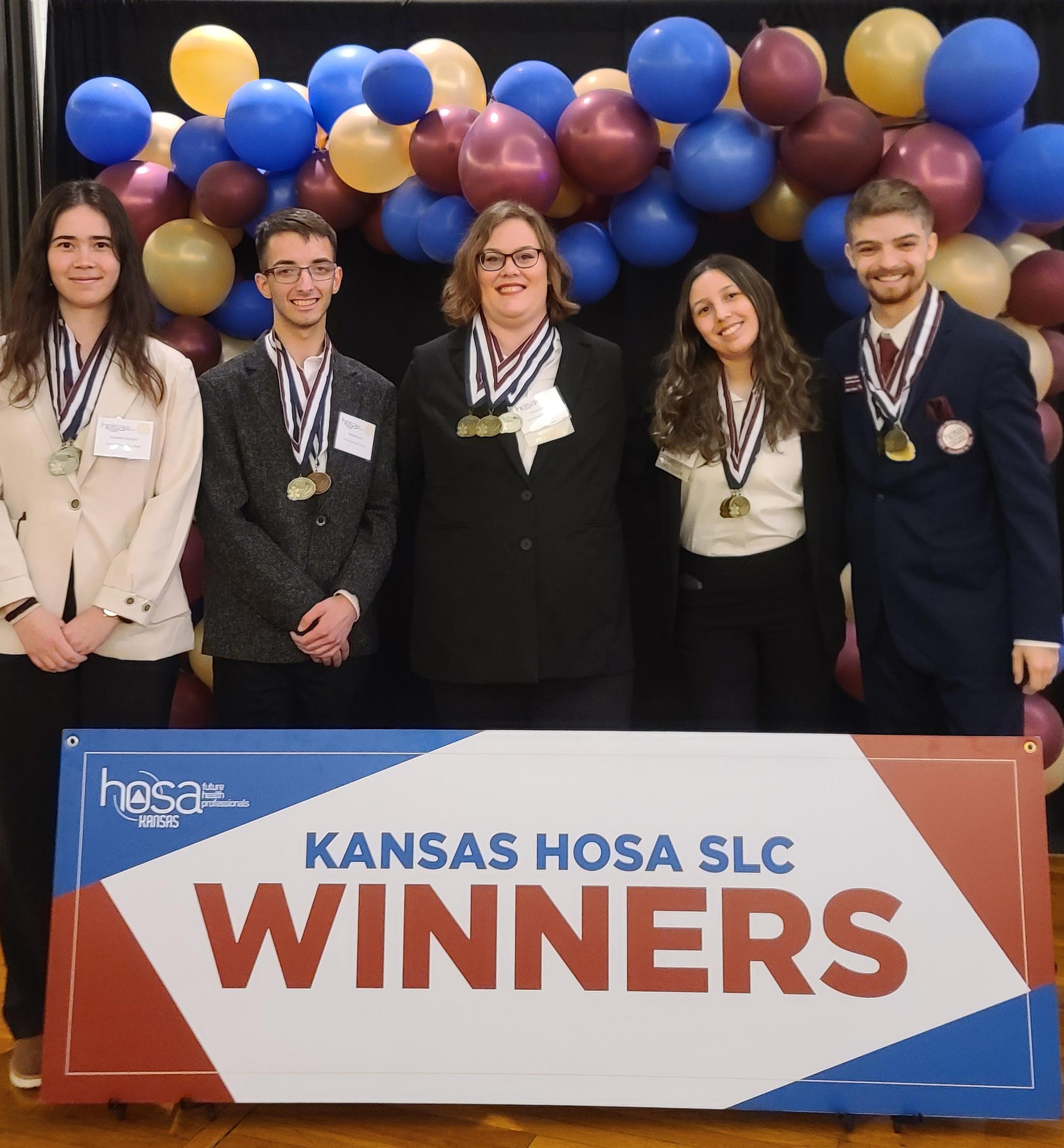 students standing with awards