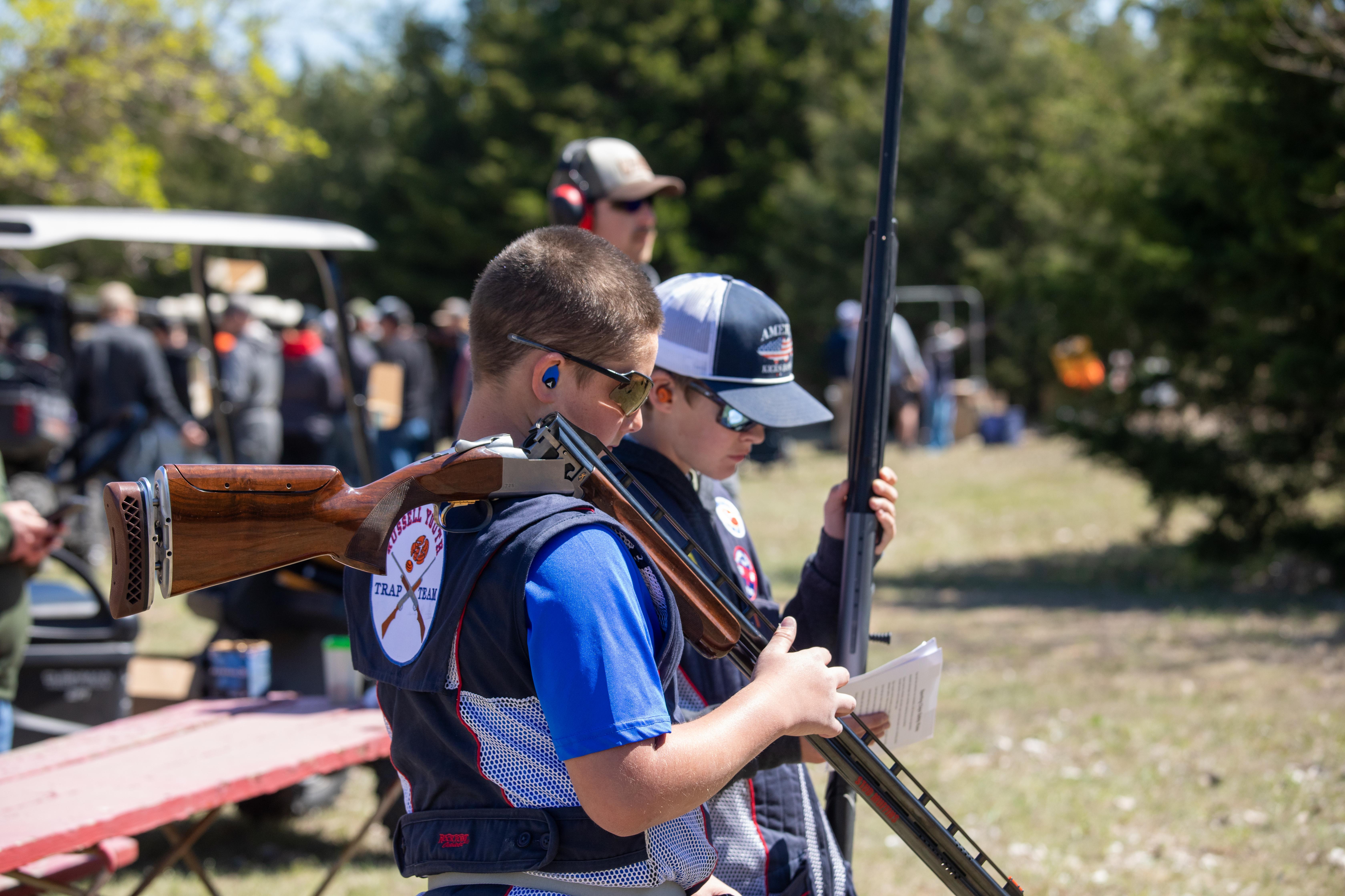 Participants at the 2024 clay shoot get ready to take aim at flying sporting clays down range.