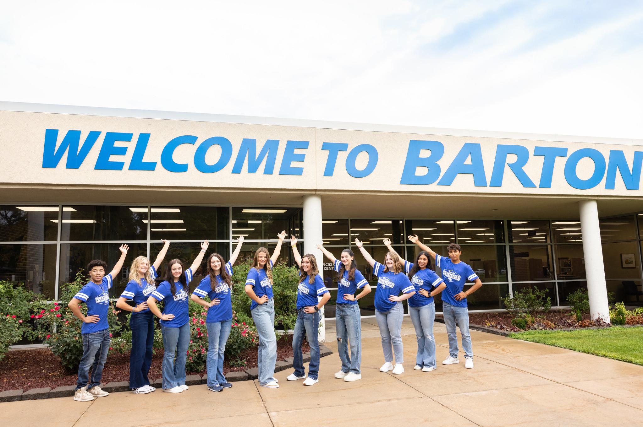 2024 ambassadors in front of Welcome to Barton building