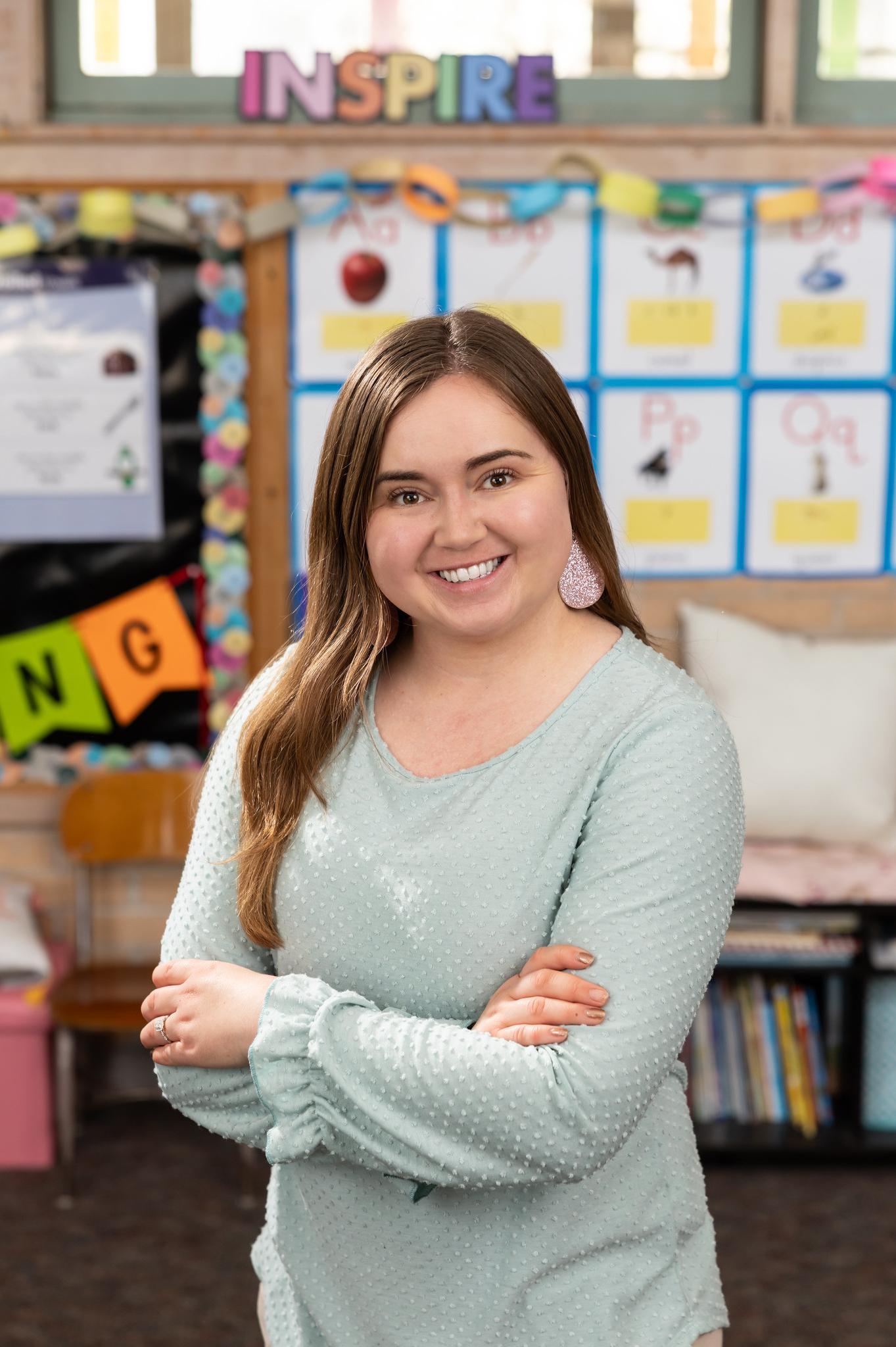 female teacher smiling in a grade school classroom
