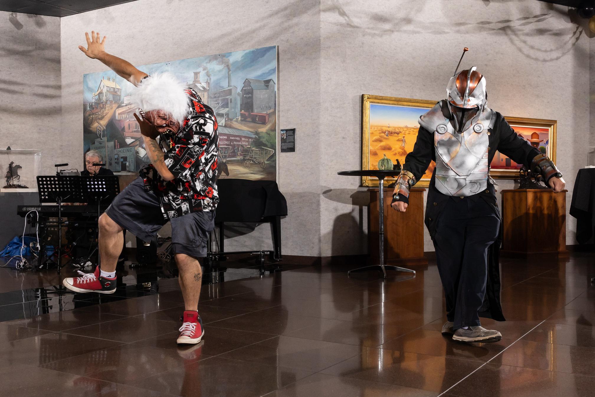 two costumed party go-ers dance