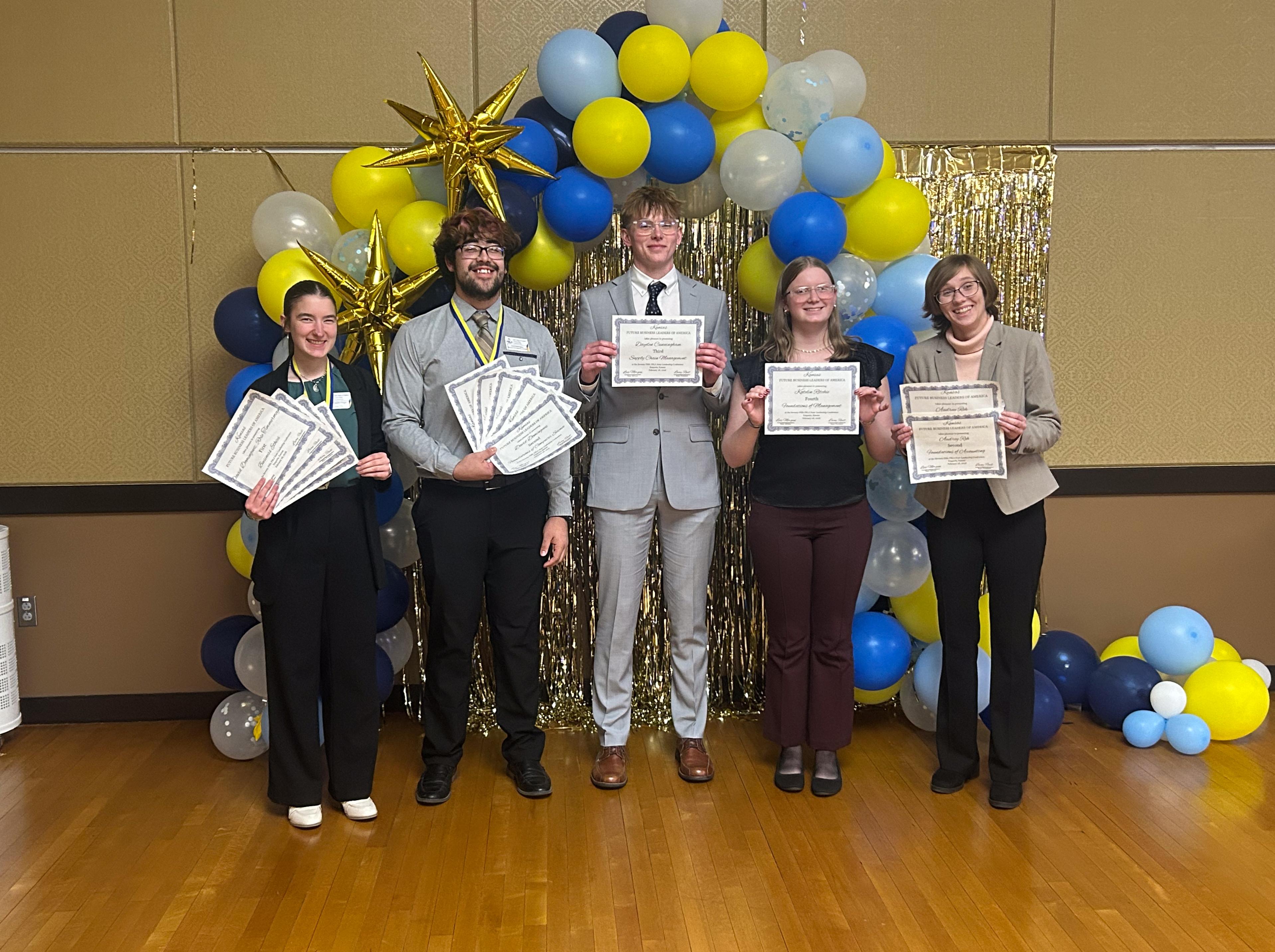 students standing with awards 