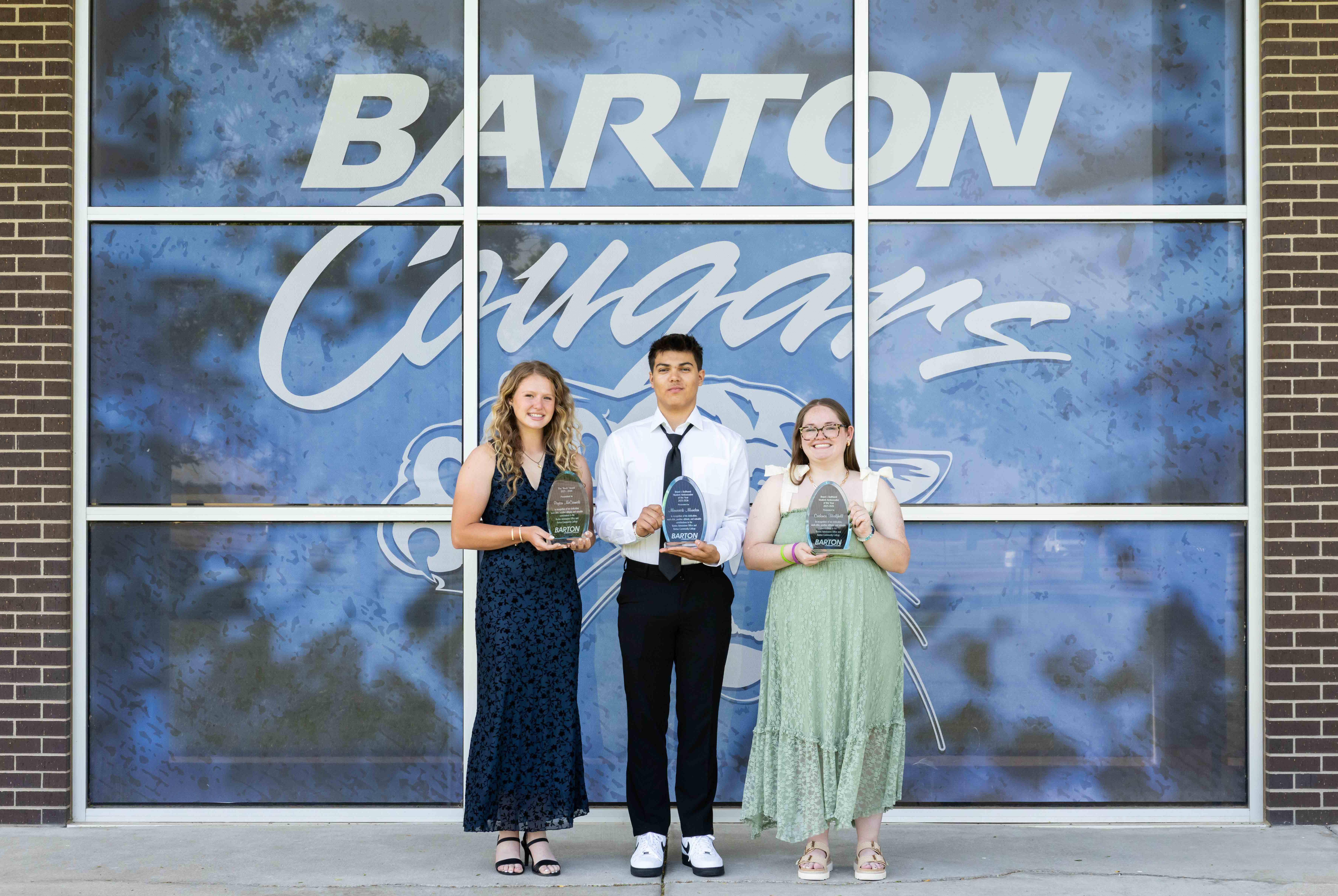 people holding glass awards