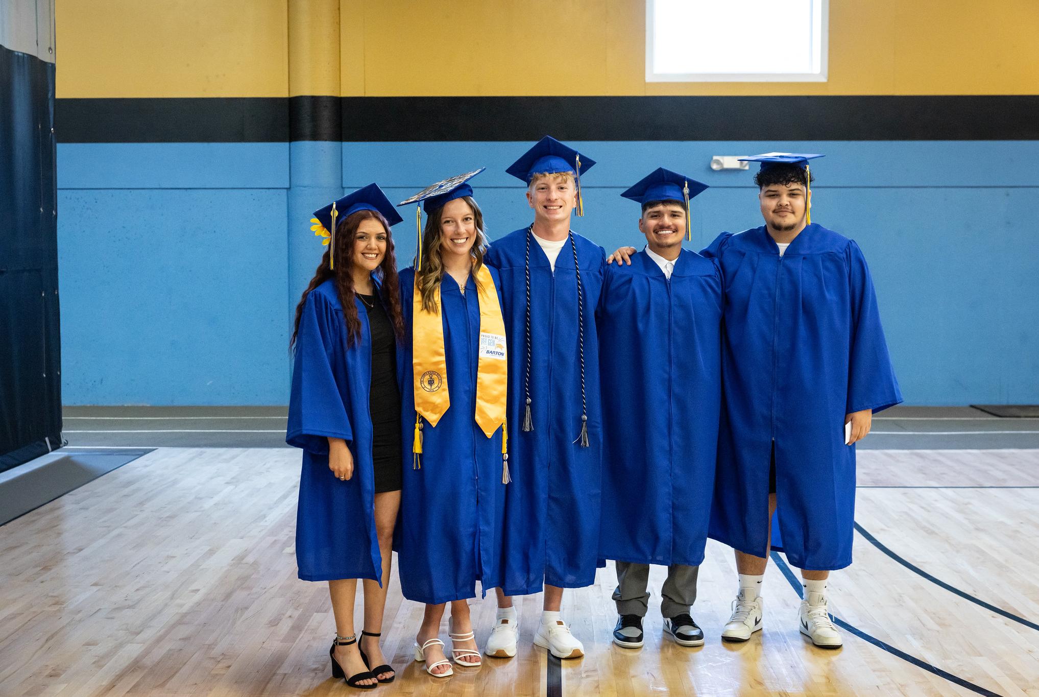 students standing in caps and gowns