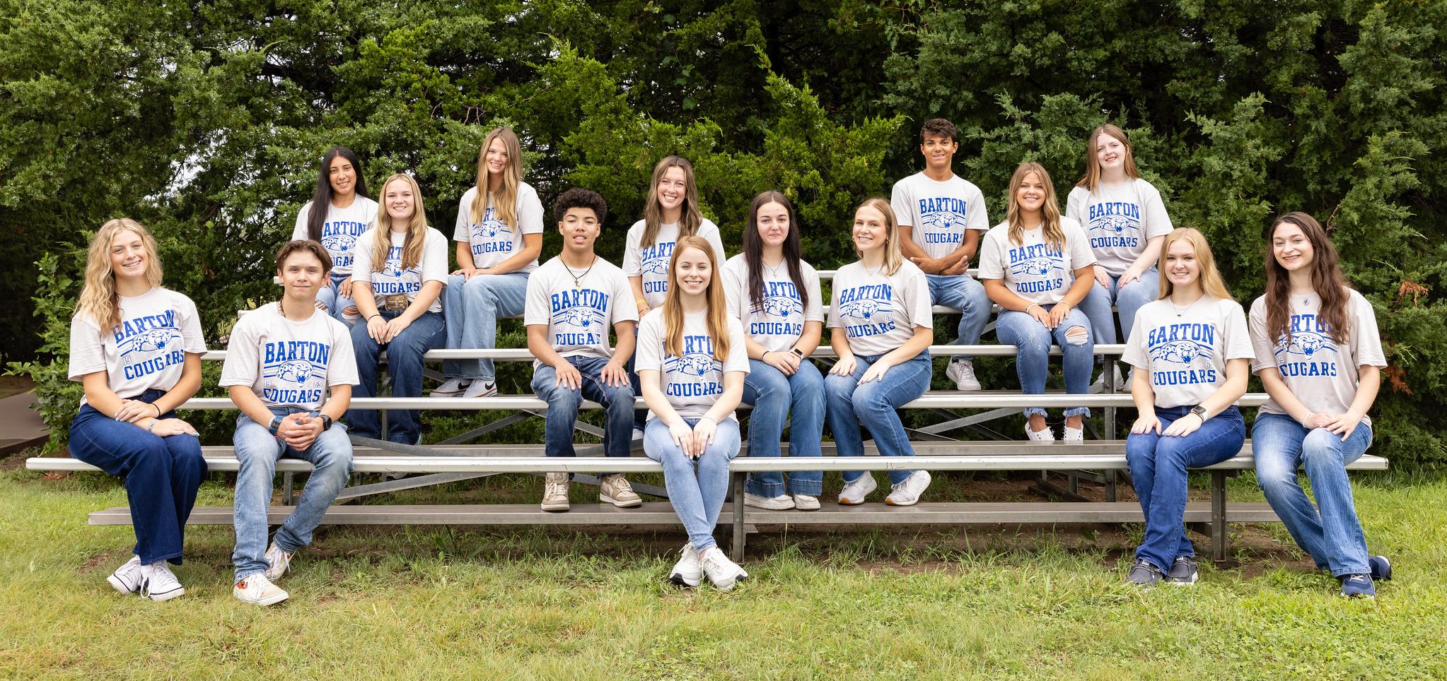 2024 ambassadors sitting on bleachers