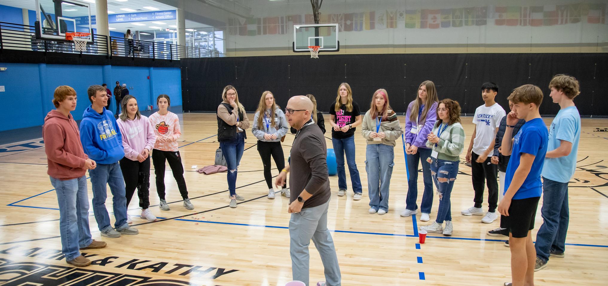 Instructor with students demonstrating physical education courses