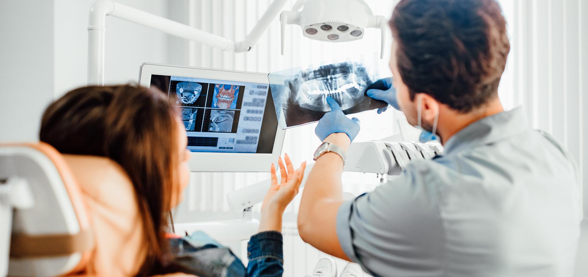 A dentist reviews patient xrays