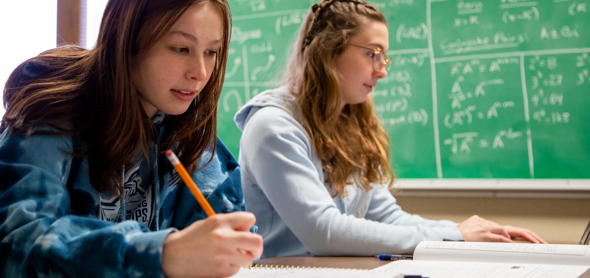 Barton students sit in a classroom doing math homework
