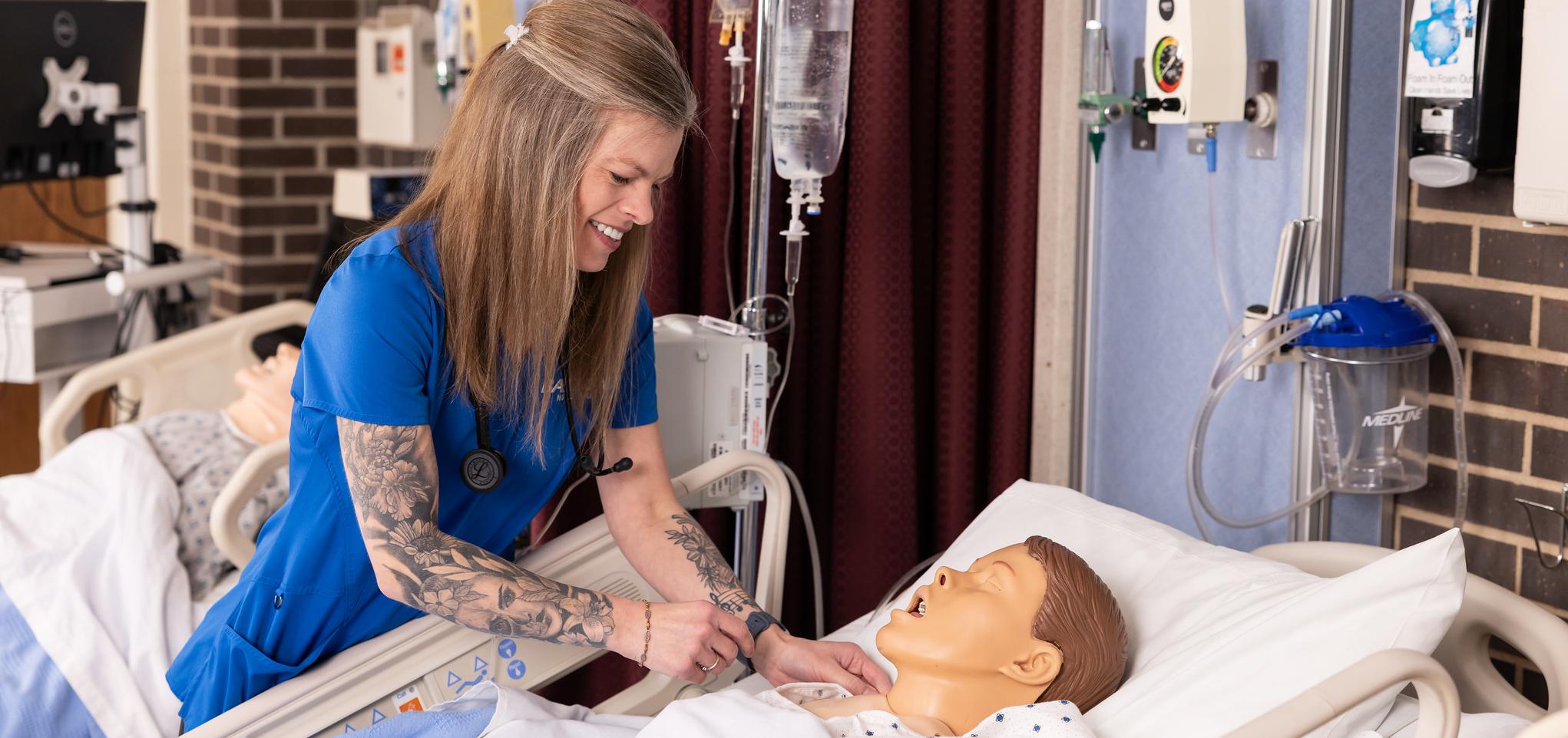 Nursing student checks mannequin