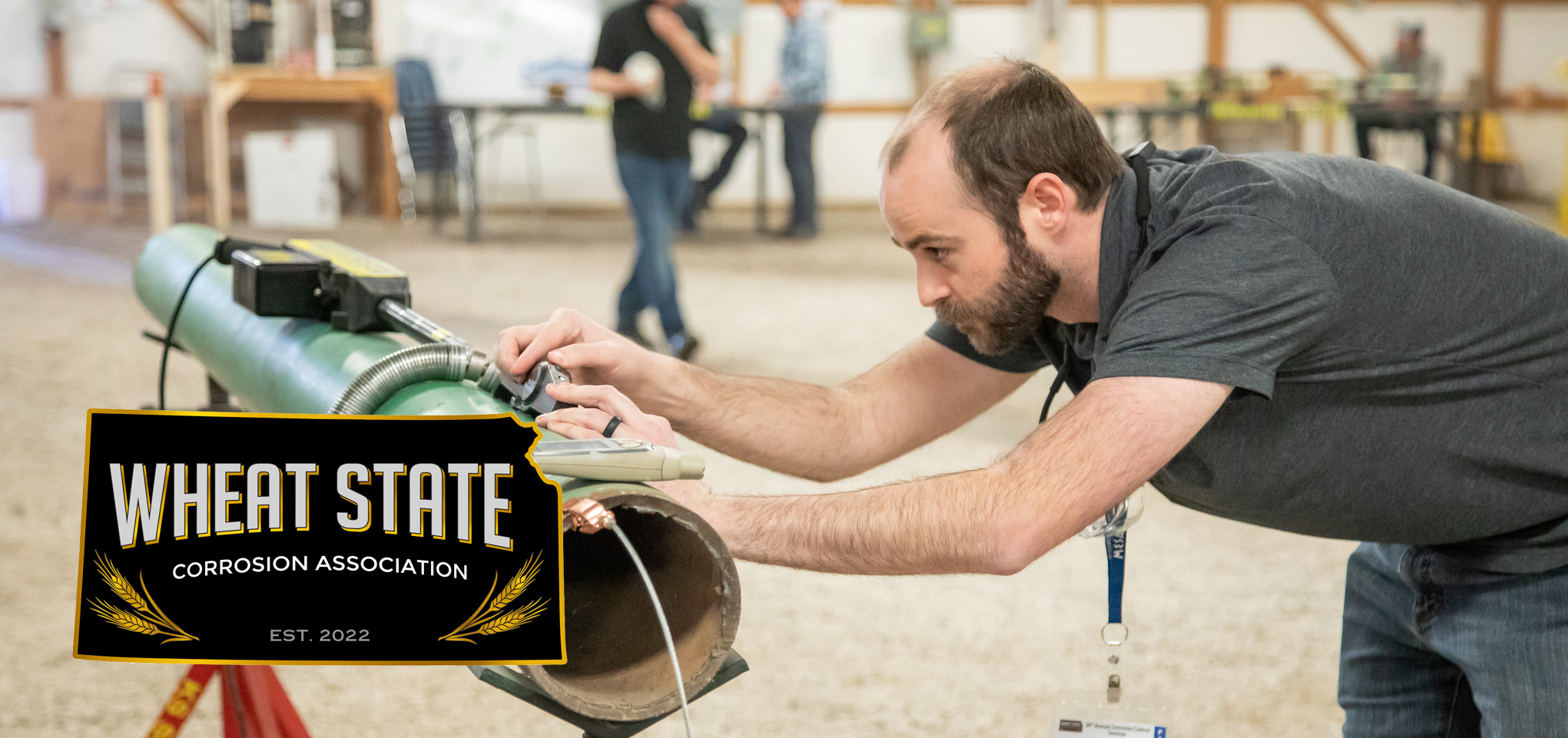 Participant measures pipe at Wheat State Corrosion Seminar