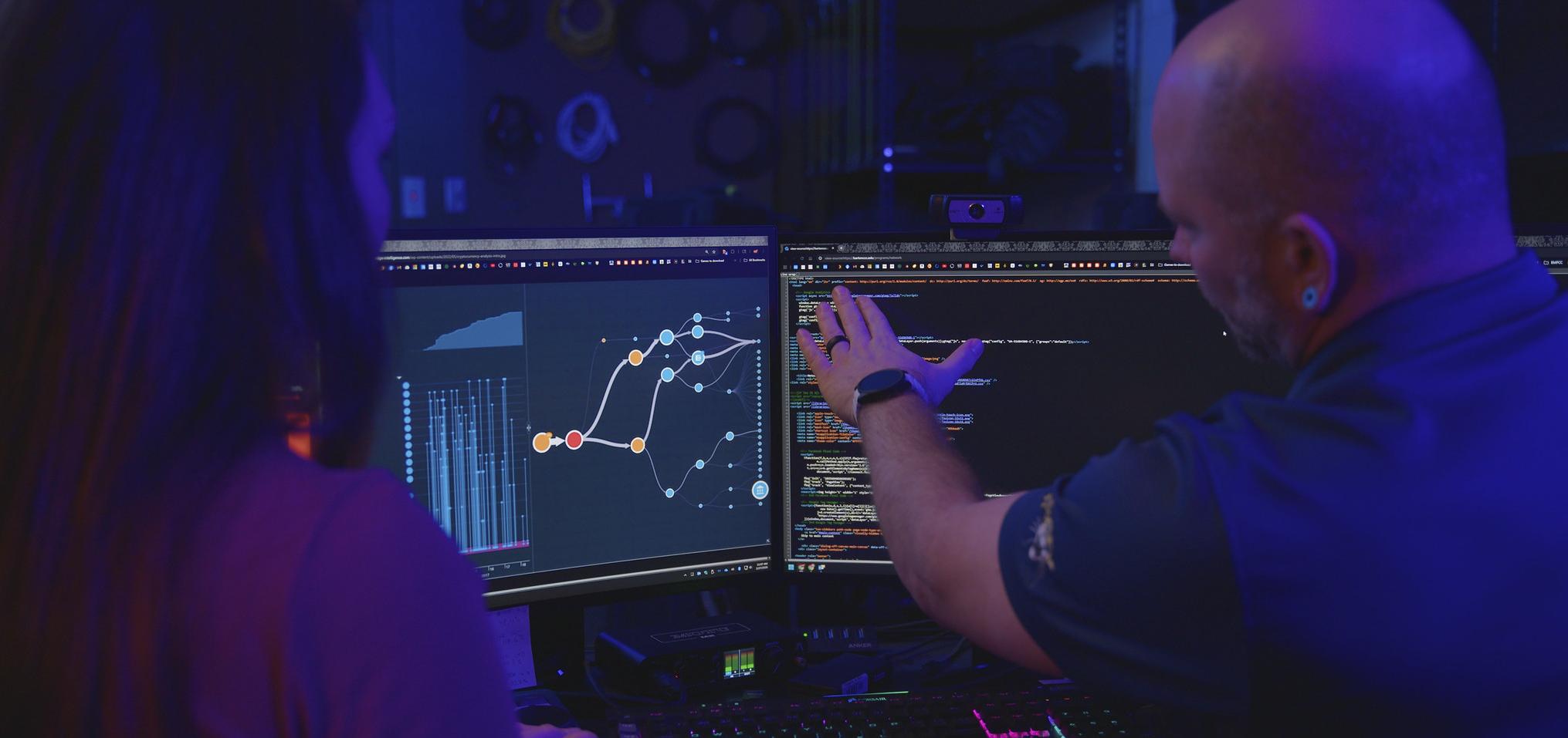 Network Specialists work on computer screens